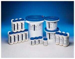 Various containers of white powder with blue lids arranged together.